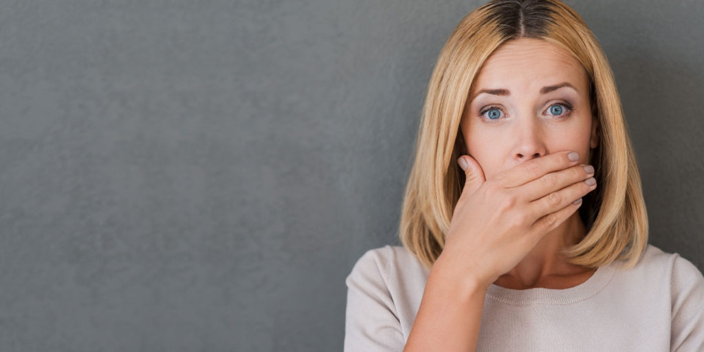 gum disease patient covering mouth